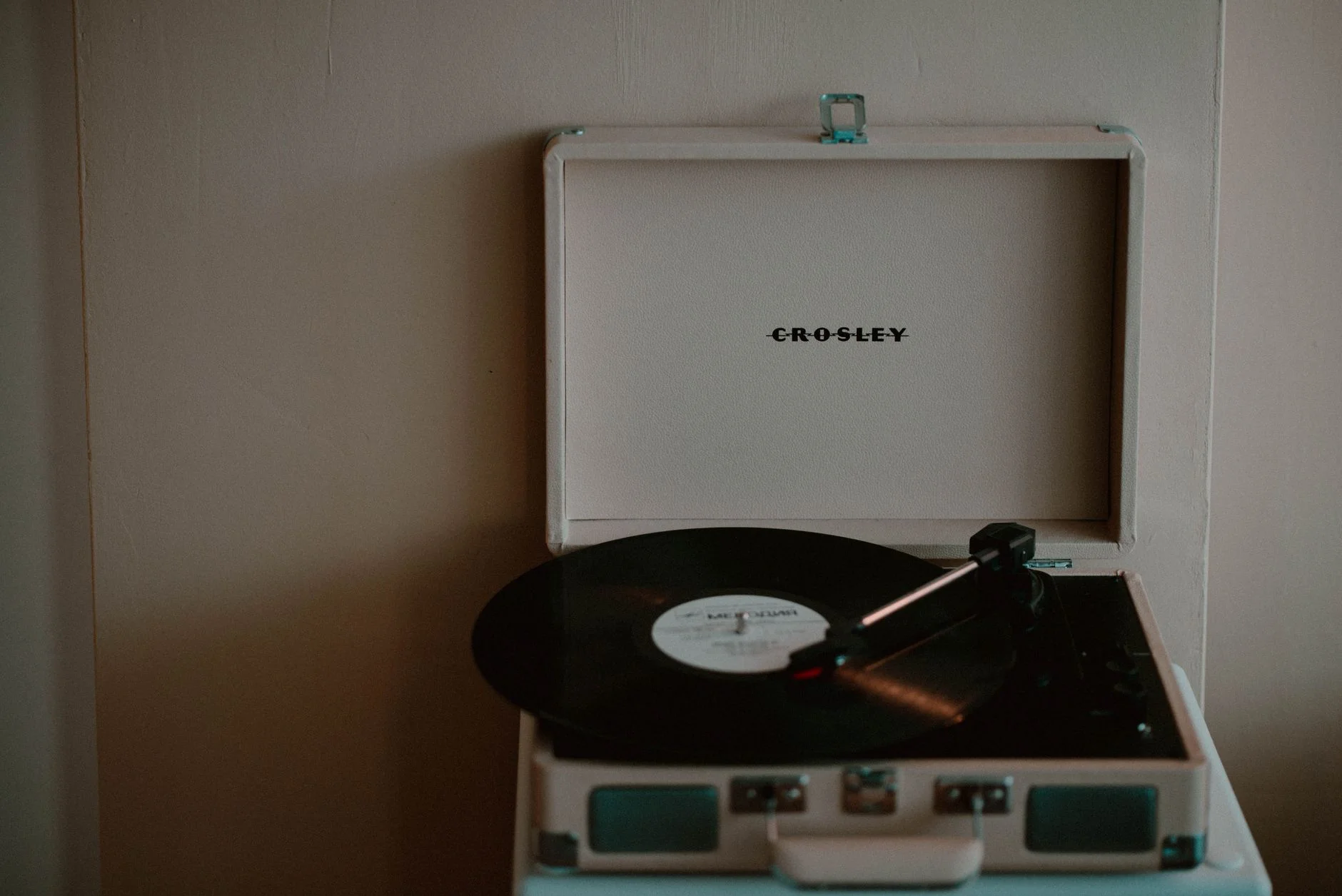 A portable turntable playing a vinyl record (stock photo)